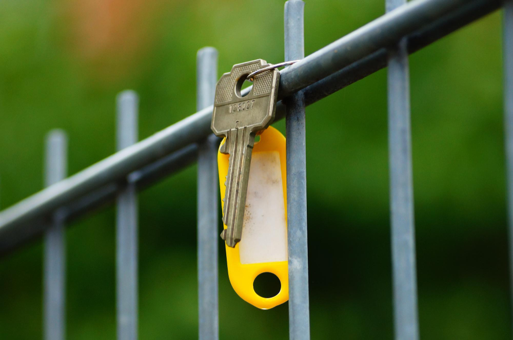 a lost key of a house hanging on a fence